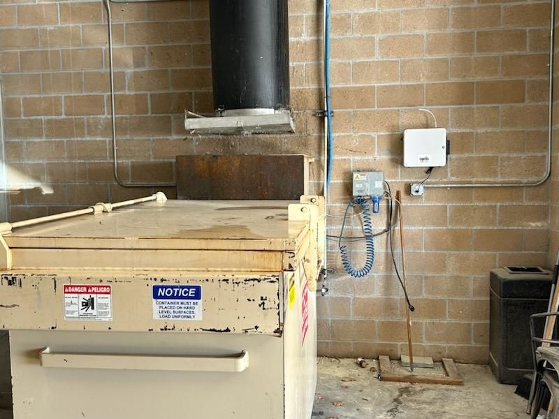 Commercial compactor connected to a building chute