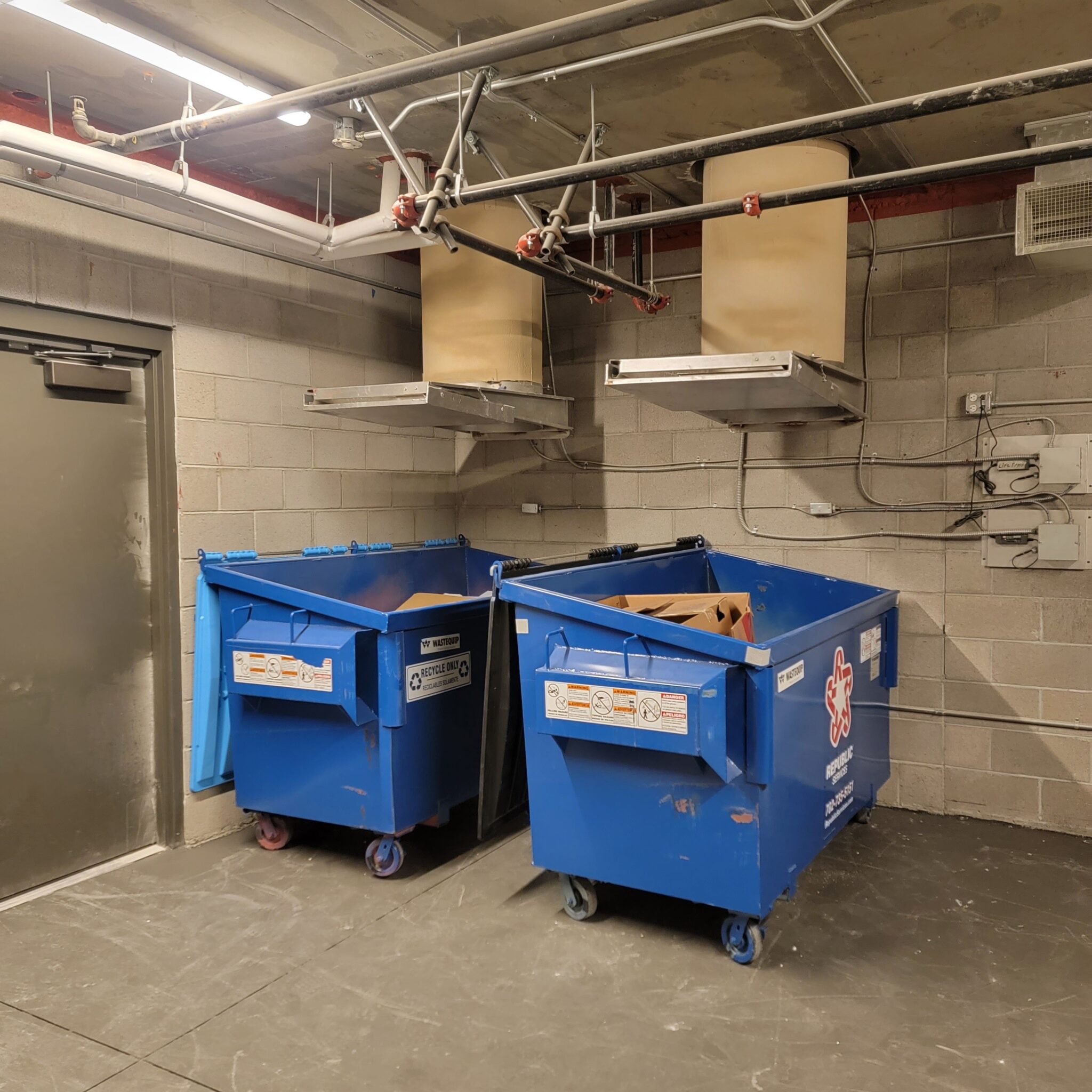 Dual recycling chutes feeding commercial collection bins