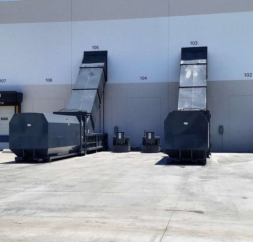 Two commercial compactors with loading chute enclosures